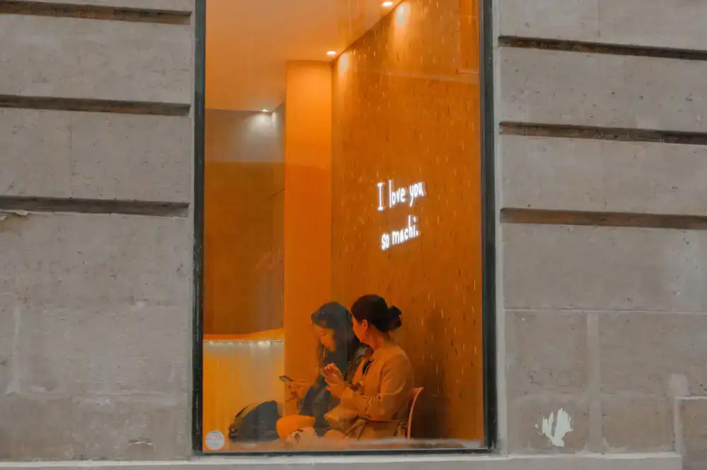 Two players observing local architecture while checking clues on a phone
