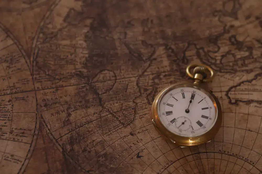 Vintage pocket watch next to a street map